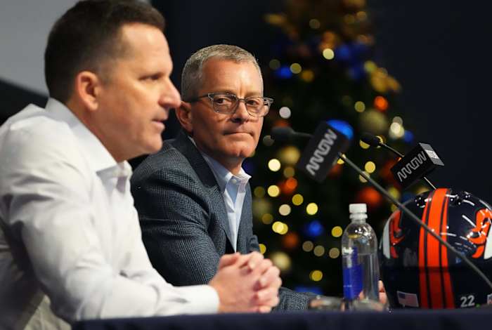 Denver Broncos CEO Greg Penner listens as general manager George Payton speaks at the UCHealth Training Center.